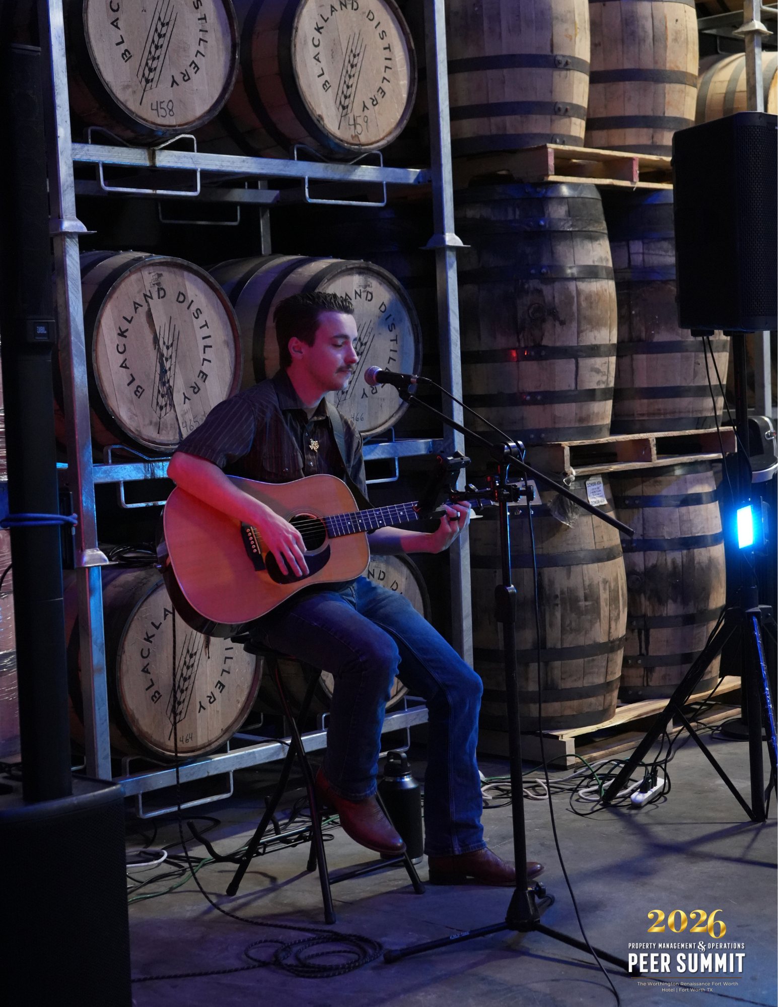 Live acoustic music in the barrel room at Blackland Distillery, Fort Worth, during a peer event planned by Modern Client.