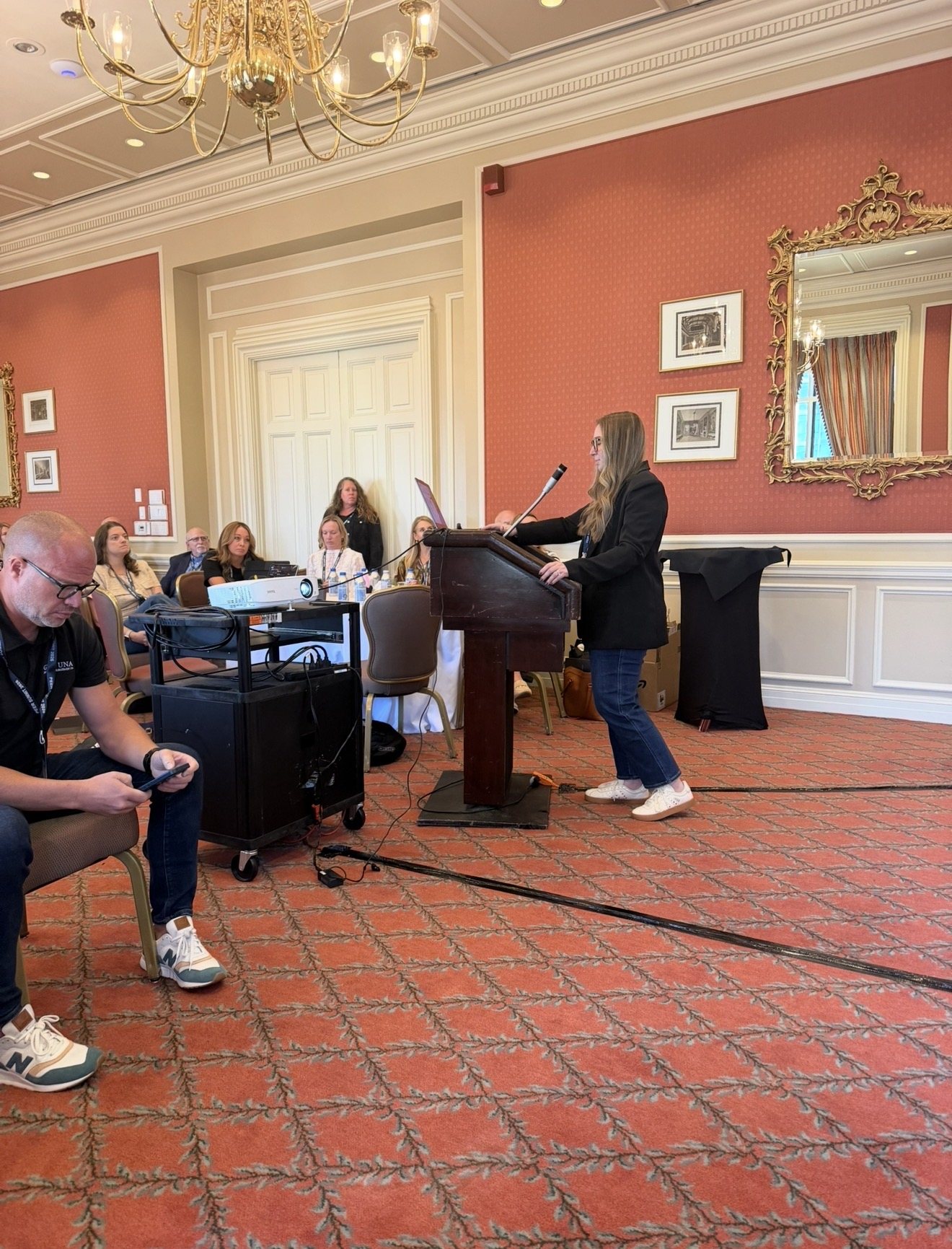 Speaker at the podium during a general session of the Property Management & Operations Peer Summit in Fort Worth, Texas, planned by Modern Client.